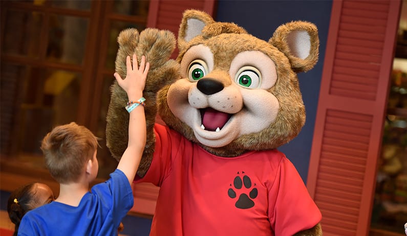 Wiley the wolf high pawing a boy