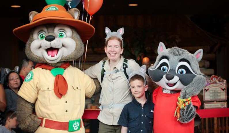 Jaime and Cale Teevan hug Great Wolf characters after their 100-mile walk