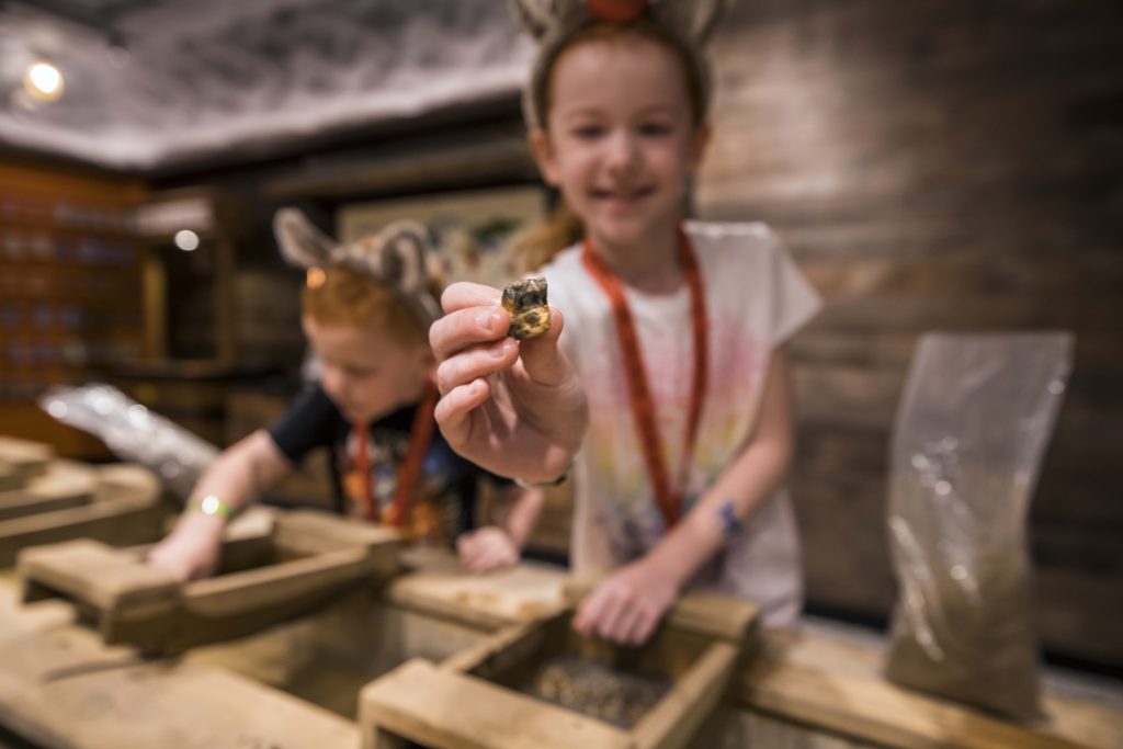 Little girl showing off rock she found in her mining slough. 